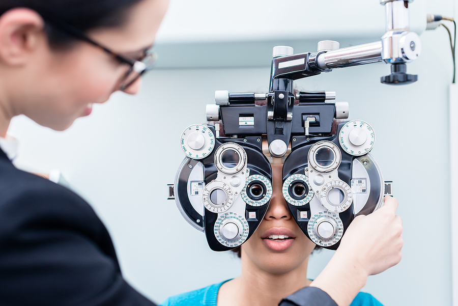 Optometrist and woman at eye examination